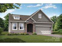 Charming new construction home with stone entryway and attached two-car garage, professionally landscaped at 125 S Prestwick Way # 41, Mooresville, NC 28115
