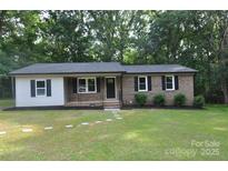 Charming single-story home with a brick facade, manicured lawn, and mature trees at 1277 Eden Dr # 18, Chester, SC 29706