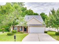Charming single-Gathering home featuring a well-maintained lawn, a two-car garage, and mature trees at 1532 Andora Dr, Rock Hill, SC 29732
