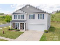 Charming two-story home featuring stone accents, blue shutters, and a well-manicured lawn at 1600 Gaston Mountain Dr, Dallas, NC 28034