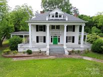 Stately two-story home featuring a vibrant green front door, classic white columns, and well-manicured lawn at 206 Rose Ter, Wadesboro, NC 28170