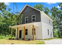 Charming two-story home with board and batten siding, complemented by natural wood porch columns at 25 Mickley Ave, Bessemer City, NC 28016