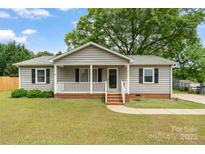 Charming single-story home featuring a welcoming front porch and well-maintained landscaping in a suburban setting at 3103 Suggs St, Belmont, NC 28012