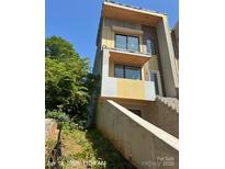 Modern multi-story home featuring large windows, and a stylish design at 312 Wesley Heights Way # A, Charlotte, NC 28208