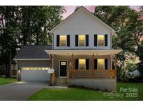 Charming two-story home with a welcoming front porch and manicured lawn at 4541 Kings Ct, Hickory, NC 28602