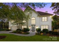 Stunning two-story white brick home with lush landscaping and a welcoming front entrance at 4622 Cotton Creek Dr, Charlotte, NC 28226