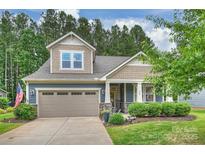 Charming two-story home with a well-manicured lawn and a two-car garage, exuding curb appeal at 528 Sandbar Pt, Clover, SC 29710