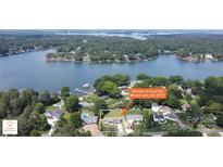Stunning aerial view of lakefront property with lush greenery and serene waters; the perfect waterfront oasis at 554 Isle Of Pines Rd, Mooresville, NC 28117