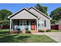Charming single-Gathering home featuring a welcoming front porch and well-maintained lawn at 650 Harry St, China Grove, NC 28023