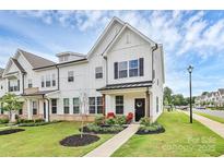 Charming white two-story townhome featuring a welcoming front porch and beautifully landscaped front yard at 720 Herlong S Ave, Rock Hill, SC 29732
