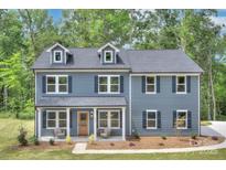 Charming two-story home with blue siding, dormer windows, and inviting front porch in a wooded setting at 1025 Harrogate Dr, Bessemer City, NC 28016