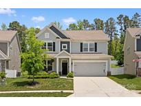 Charming two-story home with attached two-car garage and well-maintained lawn at 107 Hornbeam Ln, Mooresville, NC 28117