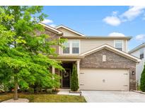 Charming two-story home featuring a mix of brick and siding, complemented by a well-manicured lawn and mature landscaping at 11518 Solstice Way, Huntersville, NC 28078