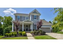 Beautiful two-story home featuring manicured landscaping and a welcoming front porch at 11718 Preservation Ln, Charlotte, NC 28278