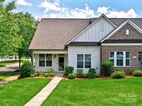 Charming home featuring manicured lawn, sidewalk, and inviting front entrance at 13421 Copley Square Dr, Huntersville, NC 28078