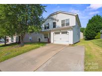 Charming two-story home with a two car garage, long driveway and a well-maintained lawn at 1457 Matthew Allen Cir, Kannapolis, NC 28081
