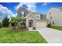 Two-story home with stone archway, two-car garage, and manicured front lawn at 1914 Loggerhead Dr, Lancaster, SC 29720