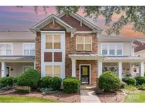 Charming townhome with stone accents, manicured landscaping, and welcoming front entrance at 2324 Bonterra Blvd, Indian Trail, NC 28079