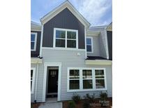 Charming townhome with gray and light gray siding, white trim, and well-manicured landscaping at 2910 Sloan Dr, Charlotte, NC 28208