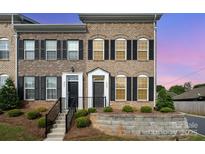 Brick townhome featuring well-maintained landscaping and a front yard at 309 N Aspen St, Lincolnton, NC 28092