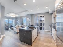 Open concept kitchen with island, stainless appliances, and views at 333 W Trade St # 1500, Charlotte, NC 28202