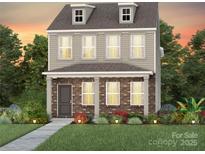 Charming two-story home with a brick facade and manicured landscaping at 3636 Edisto Pl # 120, Monroe, NC 28110