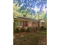 Charming single-story brick home with red shutters and a covered front porch at 3715 Vanderburg Dr, Concord, NC 28025