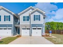 Charming townhome with a two-car garage, stone accents, and blue shutters at 4037 Port Richmond Ave # 8, Gastonia, NC 28056
