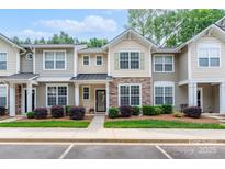 Charming townhome with stone accents, landscaped yard, and inviting entrance at 916 Coffee Tree Ln, Rock Hill, SC 29732