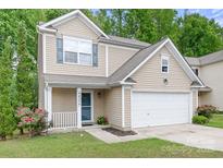 Charming two-story home with a manicured lawn and an attached garage showcasing curb appeal at 9437 Macquarie Ln, Charlotte, NC 28227