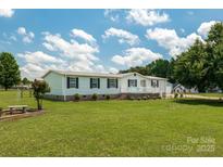 Charming single-story home with white siding, black shutters, and a well-manicured lawn at 1107 Richard Rd, Salisbury, NC 28147