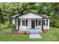 Charming home featuring white siding, black trim, and a welcoming front porch at 1155 Cedar Grove Ln, Rock Hill, SC 29732