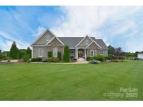 Charming home featuring stone accents and lush landscaping at 11772 Sugar Hill Rd, Davidson, NC 28036