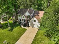Well-maintained brick and siding home with a manicured lawn and attached two-car garage at 12602 Angel Oak Dr, Huntersville, NC 28078