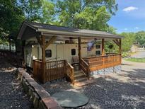 Exterior of RV with covered porch, deck and outdoor seating area at 148 Trivette Trl, Mount Gilead, NC 27306