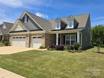 Charming home featuring a two-car garage, well-manicured lawn, and inviting curb appeal at 17028 River Race Dr, Huntersville, NC 28078