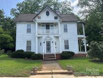 Two-story home with columns, front yard with greenery, sidewalk leading to the house at 204 N Gaston St, Kings Mountain, NC 28086