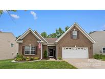 Charming brick home featuring an attached two-car garage and manicured lawn at 286 Mallard Head Dr, Rock Hill, SC 29732