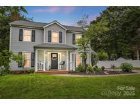 Charming two-story home featuring a welcoming front porch and well-maintained landscaping at 314 Sunnywood Ln, Charlotte, NC 28270