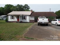 Charming single-Gathering home with a metal roof, carport, and mature trees at 5004 King Wilkinson Rd, Denver, NC 28037