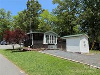 Charming home with a well-maintained yard, storage shed, and gravel driveway, perfect for a relaxed lifestyle at 102 Papoose Ct # D117, Mount Gilead, NC 27306
