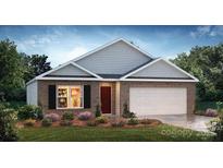 Charming single-story home with brick and siding, complemented by a well-manicured lawn and colorful landscaping at 1053 Horizon Ln, Chester, SC 29706