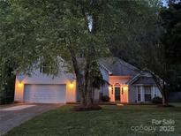 Charming two-story home with a well-maintained lawn and attached garage at 125 Canopy Ct, Mooresville, NC 28115
