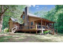 Inviting two-story home with a cozy covered porch, brick chimney, and lush green surroundings at 1371 Hawks Nest Rd, York, SC 29745