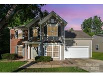 Charming two-story home featuring a partial brick facade, neutral siding, and an attached two-car garage at 152 Hampshire Dr, Mooresville, NC 28115