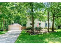 Charming home with mature trees, attached garage, and well-manicured lawn at 1739 Lesa Lin Dr, Monroe, NC 28112