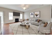 Bright living room with fireplace, ceiling fan, modern decor and stylish neutral color palette at 2169 Shady Pond Dr, Clover, SC 29710
