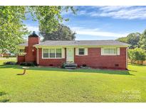 Charming red brick home features a well-manicured lawn and classic design details at 2601 Marldale St, Gastonia, NC 28052