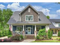 Charming two-story home featuring a welcoming front porch, beautiful landscaping, and an inviting curb appeal at 2829 Holt St, Charlotte, NC 28205