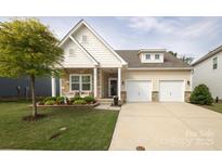 Charming two-story home boasts a well-manicured lawn, stone accents, and a convenient two-car garage at 363 Bellingrath Blvd, Rock Hill, SC 29730